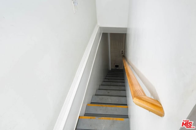 stairs with concrete flooring