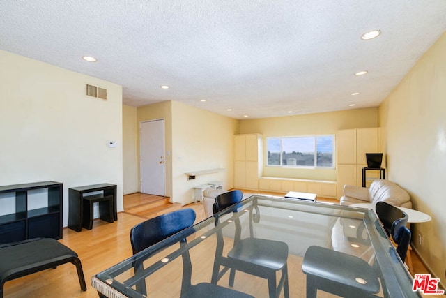 interior space with light hardwood / wood-style floors and a textured ceiling