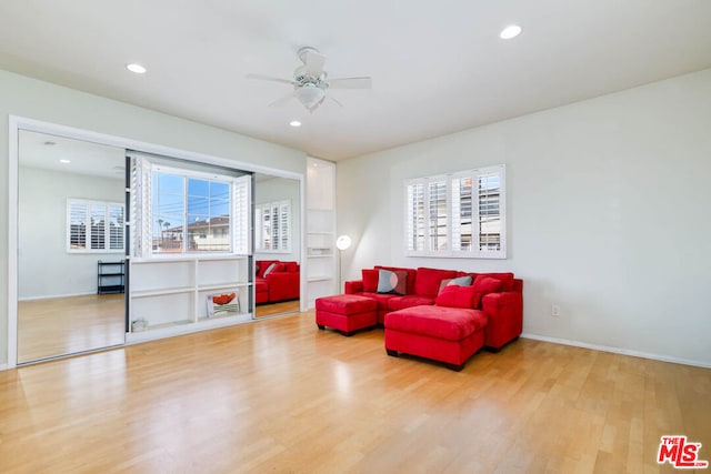 living area with light hardwood / wood-style flooring and ceiling fan