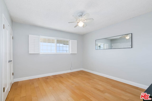 unfurnished room with ceiling fan, wood-type flooring, and a healthy amount of sunlight