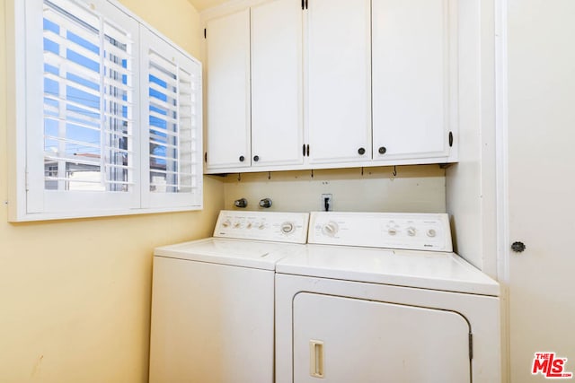 laundry area featuring cabinets and separate washer and dryer