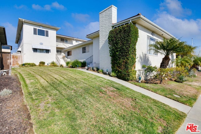 rear view of house with a yard