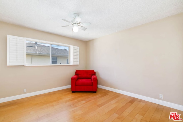 unfurnished room featuring hardwood / wood-style flooring, a textured ceiling, and ceiling fan