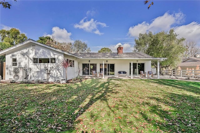 back of house featuring a yard and a patio area