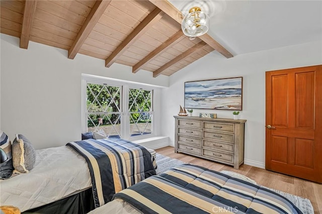 bedroom with lofted ceiling with beams, light hardwood / wood-style floors, and wooden ceiling