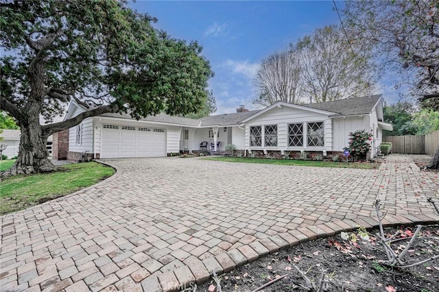 ranch-style house featuring a garage and a front yard