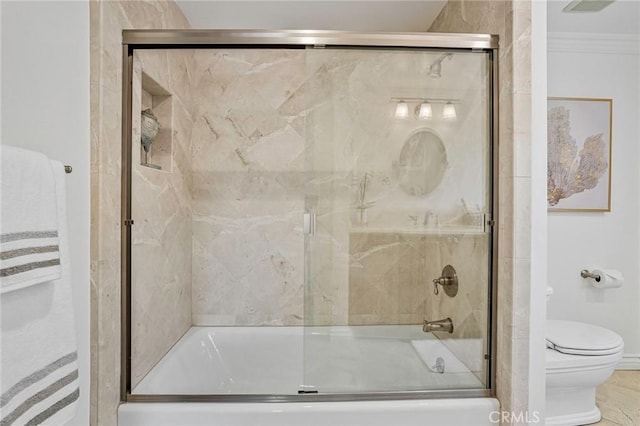 bathroom featuring ornamental molding and toilet