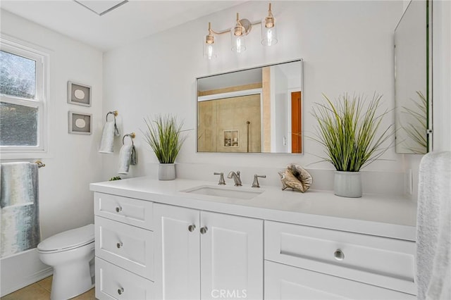 bathroom featuring vanity, toilet, a shower with shower door, and tile patterned flooring