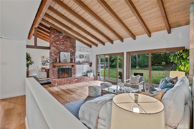 living room featuring wooden ceiling, a fireplace, high vaulted ceiling, and light wood-type flooring