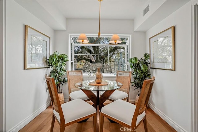 dining area with light hardwood / wood-style floors