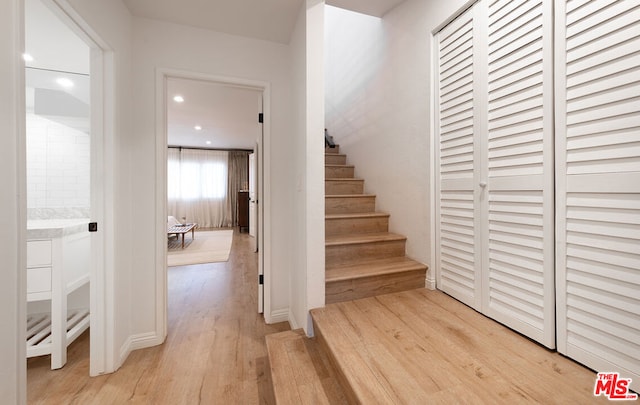 stairs featuring hardwood / wood-style floors