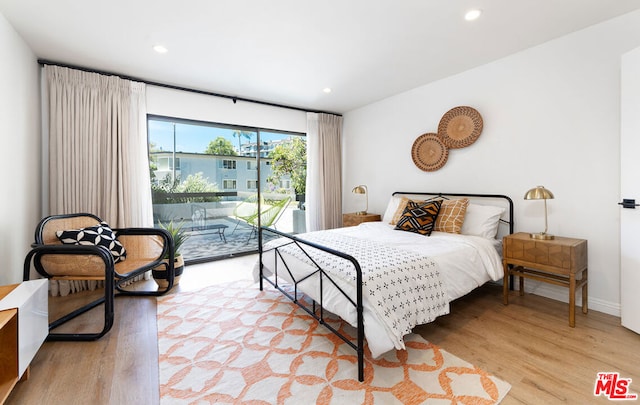 bedroom with access to outside and light hardwood / wood-style floors