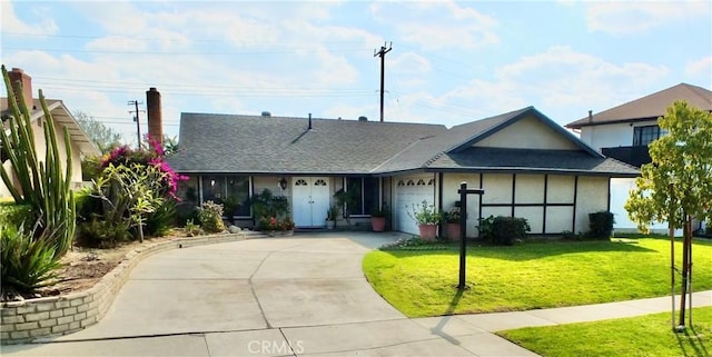 view of front of home featuring a garage and a front lawn