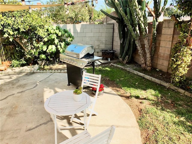 view of patio / terrace featuring a fire pit and grilling area