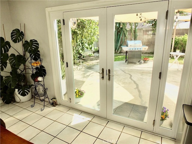 entryway with light tile patterned floors and french doors