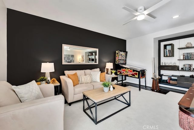 carpeted living room with ceiling fan