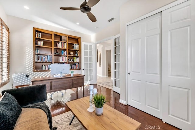 home office with french doors, ceiling fan, and dark hardwood / wood-style flooring