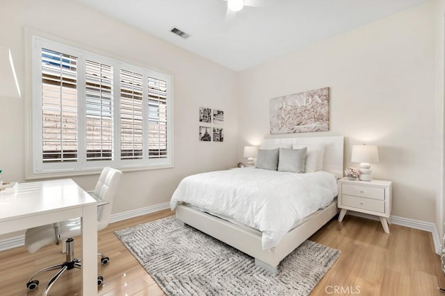 bedroom with ceiling fan and light wood-type flooring