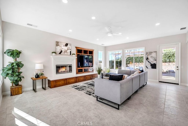 living room with light tile patterned floors and ceiling fan