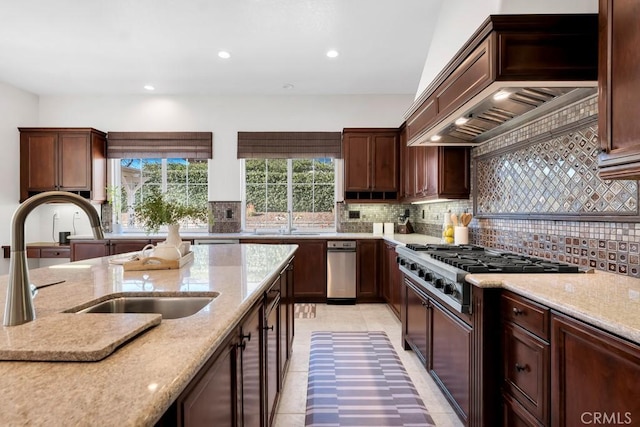 kitchen featuring sink, light stone counters, stainless steel gas cooktop, decorative backsplash, and custom exhaust hood