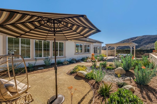 exterior space featuring a mountain view and a patio