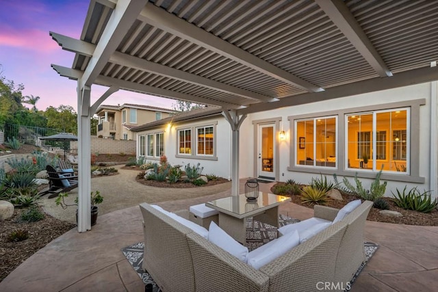 patio terrace at dusk with a pergola