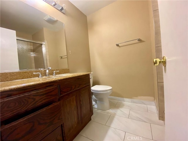 bathroom featuring vanity, a shower with door, tile patterned floors, and toilet