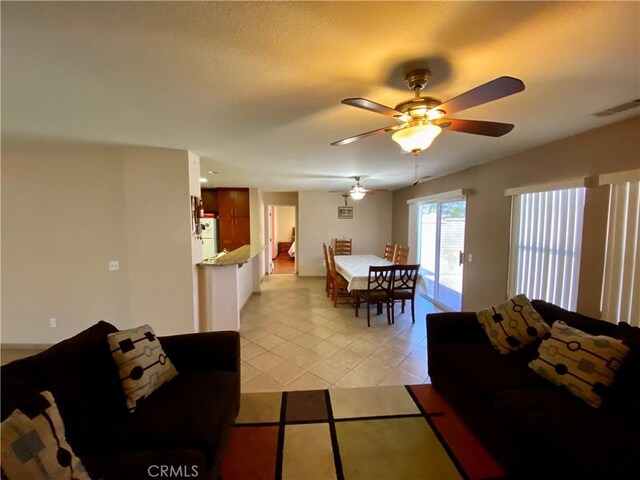 tiled living room with ceiling fan