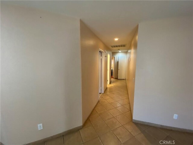 hall with light tile patterned flooring