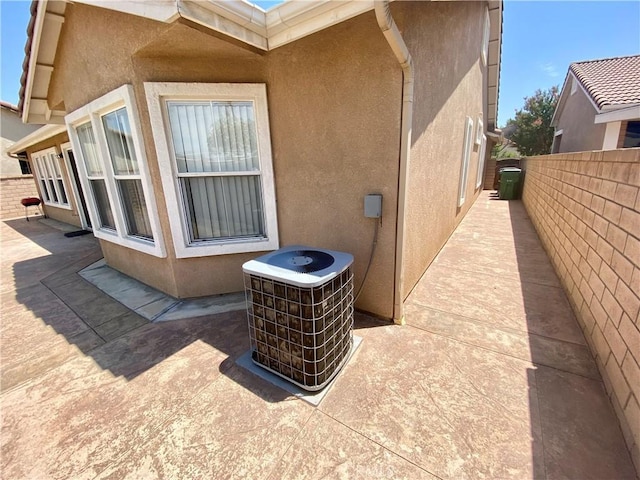 view of side of home featuring central AC unit and a patio area