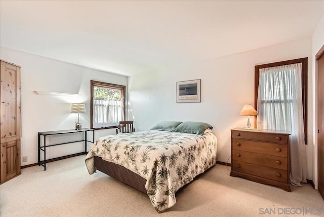 bedroom featuring light colored carpet