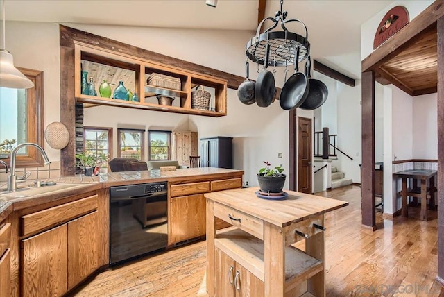 kitchen with decorative light fixtures, dishwasher, tile countertops, and light wood-type flooring