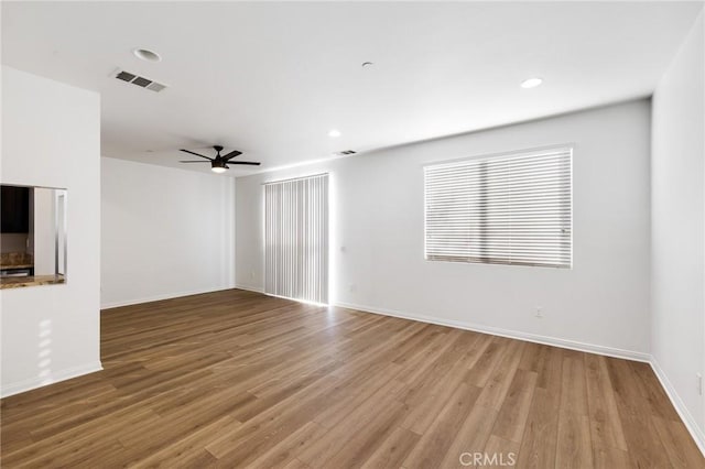 unfurnished living room featuring ceiling fan and wood-type flooring