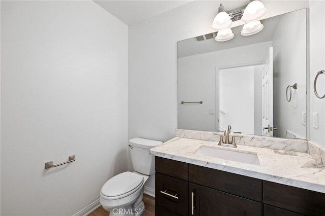 bathroom with vanity, hardwood / wood-style floors, and toilet