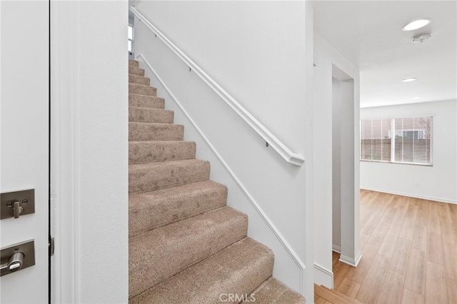 stairs featuring wood-type flooring