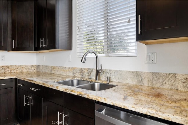 kitchen featuring dishwasher, light stone countertops, sink, and dark brown cabinets