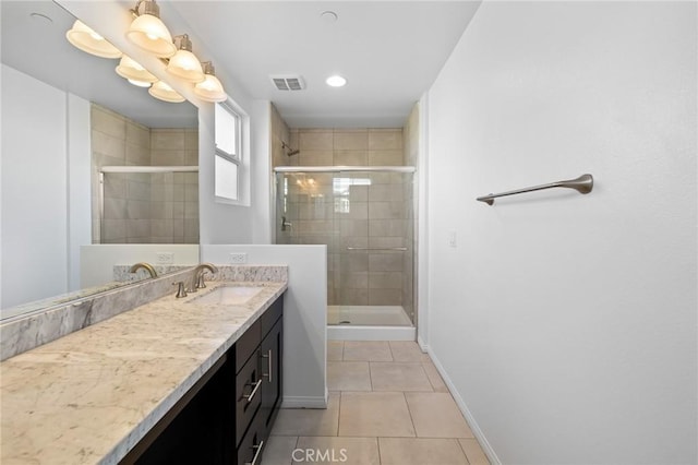 bathroom with vanity, an enclosed shower, and tile patterned flooring