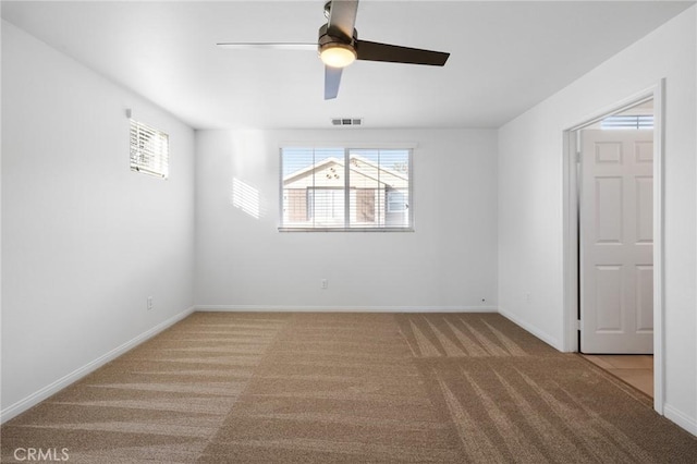 empty room featuring light carpet and ceiling fan