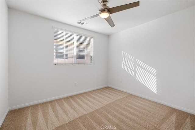 empty room with light colored carpet and ceiling fan