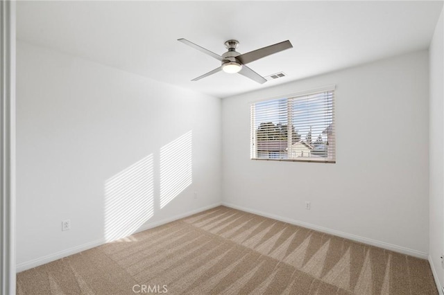 empty room featuring ceiling fan and carpet flooring