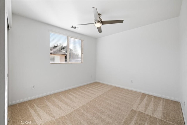 empty room featuring carpet flooring and ceiling fan