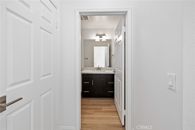 bathroom with vanity and wood-type flooring