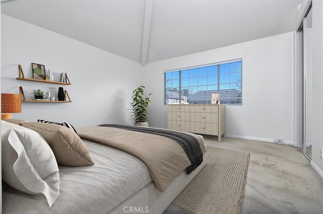 carpeted bedroom featuring lofted ceiling with beams