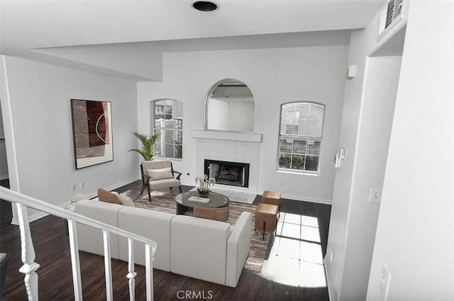 living room with a fireplace and dark hardwood / wood-style floors