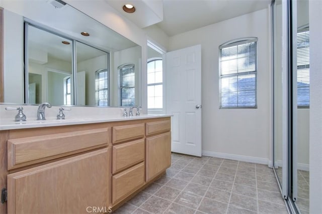 bathroom with tile patterned floors and vanity