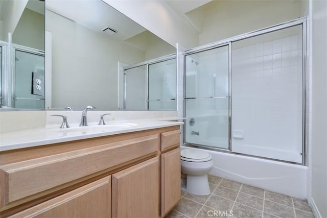 full bathroom with vanity, combined bath / shower with glass door, tile patterned floors, and toilet