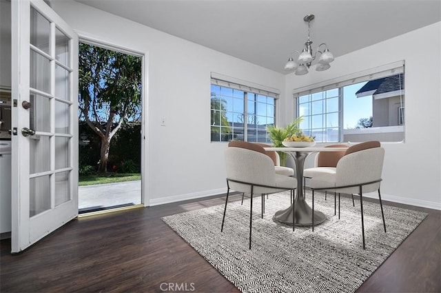 dining room featuring dark hardwood / wood-style flooring and an inviting chandelier