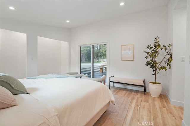 bedroom with access to exterior and light hardwood / wood-style floors