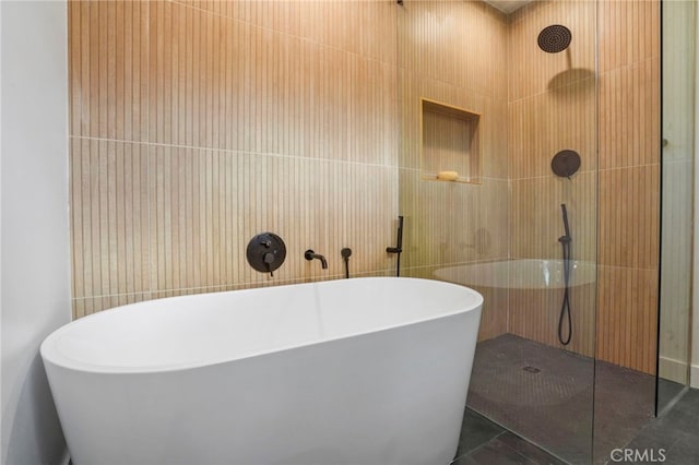 bathroom featuring tile walls, tile patterned flooring, and shower with separate bathtub