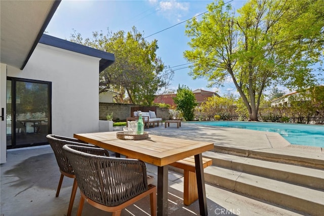 view of patio / terrace featuring a fenced in pool and an outdoor living space